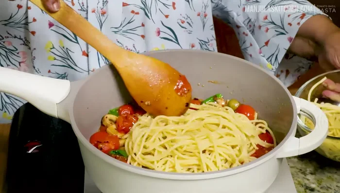 Add the cooked pasta to the sauce and mix well. Add reserved pasta water if needed to adjust consistency.