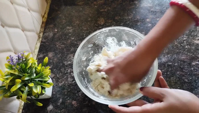 Gradually add water to the flour mixture, kneading to form a firm, smooth dough. Do not add all the water at once.