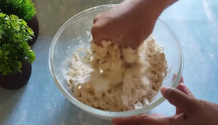 Gradually add water to form a stiff dough. Knead well.