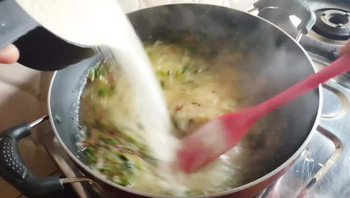 Gradually add the semolina, stirring continuously to prevent lumps, until a dough-like consistency is reached.