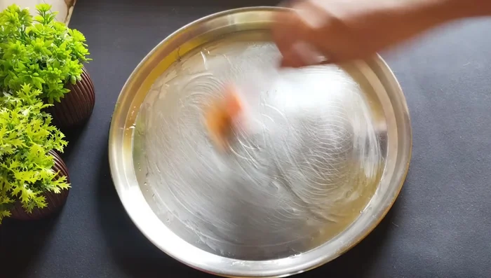 Transfer the mixture to an oiled plate or tray and spread it evenly to about 1/2 inch thickness.