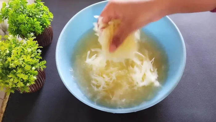Wash the grated potatoes thoroughly 3-4 times to remove excess starch.