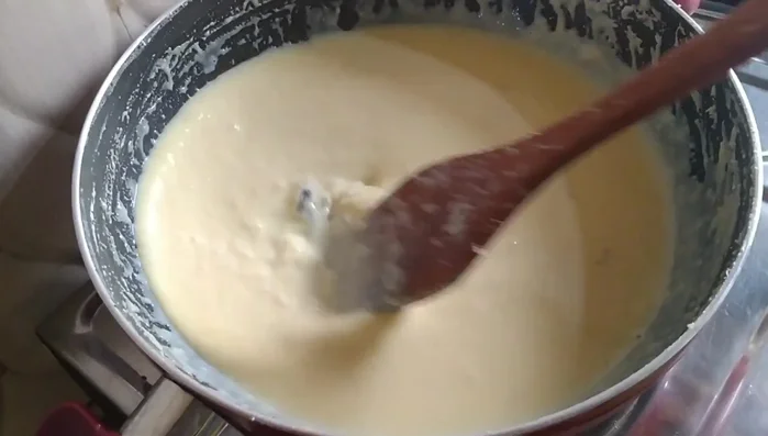 Continue to cook and stir the milk mixture until it thickens considerably and begins to leave the sides of the pan.