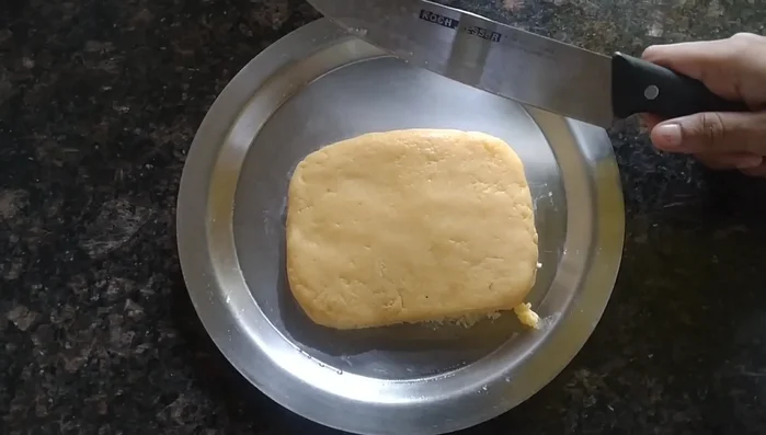 Once set, cut the barfi into desired shapes and garnish with saffron threads (optional).