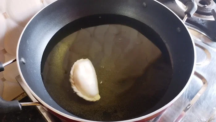 Heat oil in a pan. Fry the Gujiyas on low heat, turning occasionally, until golden brown and crispy.