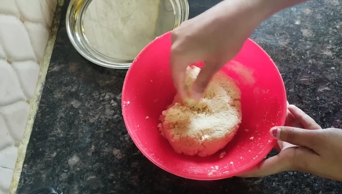 Wash your hands, apply oil, and shape the dough into small, round balls, similar to making pedas. You can flatten them slightly.