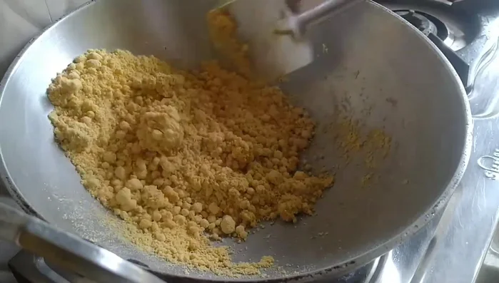 Continue frying on low heat until the gram flour releases its oil and changes color. Add 2-3 spoons of ghee if it looks dry. This step may take some time and patience.