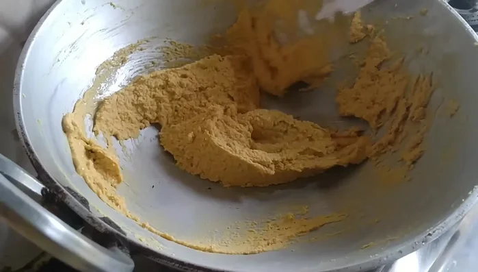 Once the gram flour is well-roasted and its color has changed, turn off the heat and transfer it to a plate to cool.