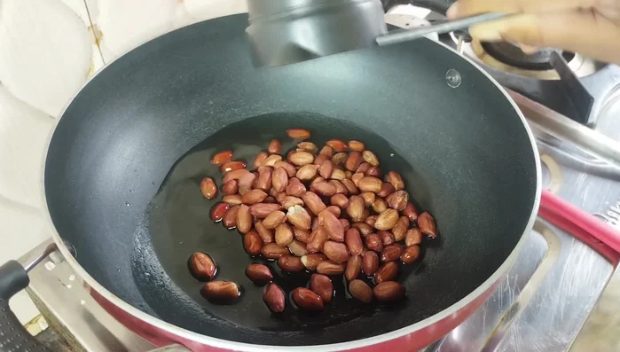 Roast Peanuts and Coconut: Heat the pan again, add 2-3 tablespoons of oil. Add 1/2 cup peanuts and roast until color changes. Then, add dry coconut and roast until fragrant.
