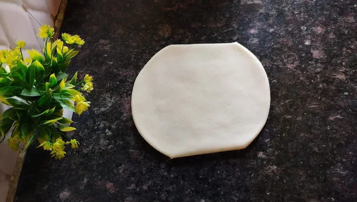Cut the rolled dough into desired shapes (squares, diamonds, etc.).