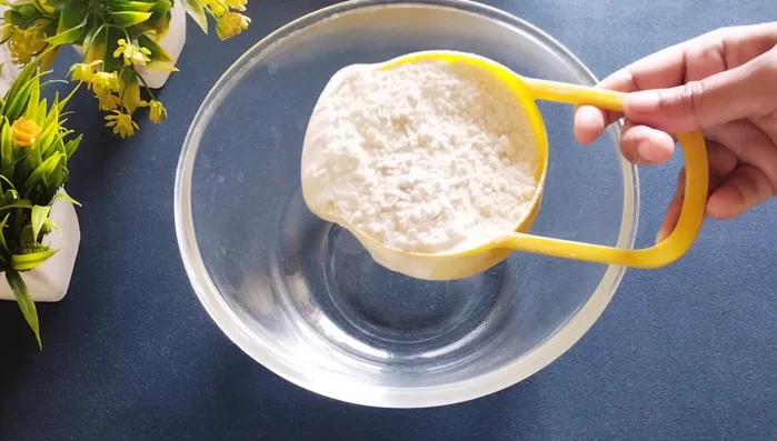 Take a utensil and add two cups of refined flour.