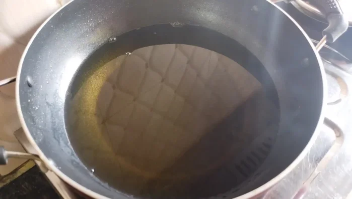 Heat oil in a frying pan. Once hot, drop spoonfuls of batter into the hot oil, ensuring each spoonful is dropped in the center of the pan and left undisturbed.