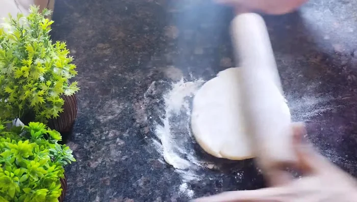 Roll each ball into a thin circle, dusting with dry flour to prevent sticking.
