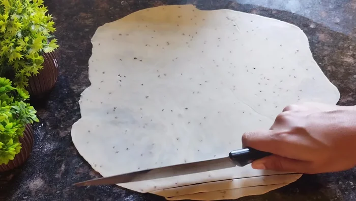 Cut the rolled dough into small, thin pieces (squares or diamonds).