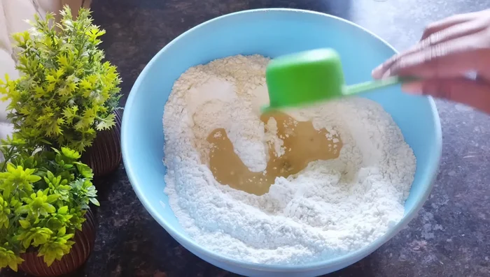 Add refined oil and rub it into the flour until crumbly.