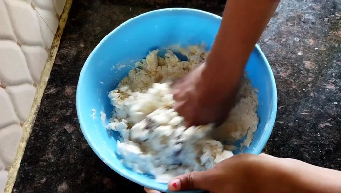 Gradually add water, kneading to form a firm, stiff dough. Let it rest.