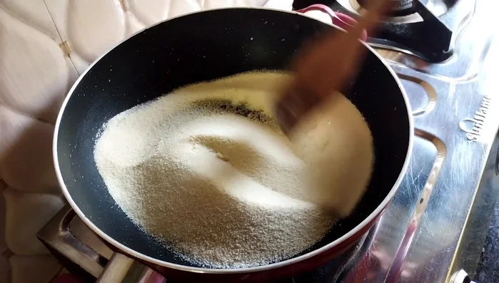 Add grated dry coconut, raisins, and cashews. Mix and roast briefly.