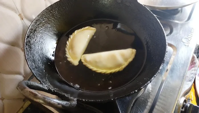 Deep fry in hot oil on low heat until golden brown and puffed up.