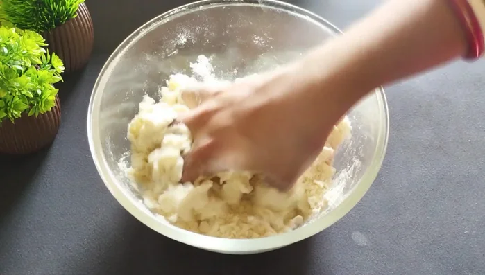 Gradually add water to form a stiff dough. Do not make it too soft.