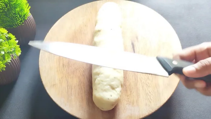 Shape the dough into a cylinder and cut it into small, equal-sized pieces.