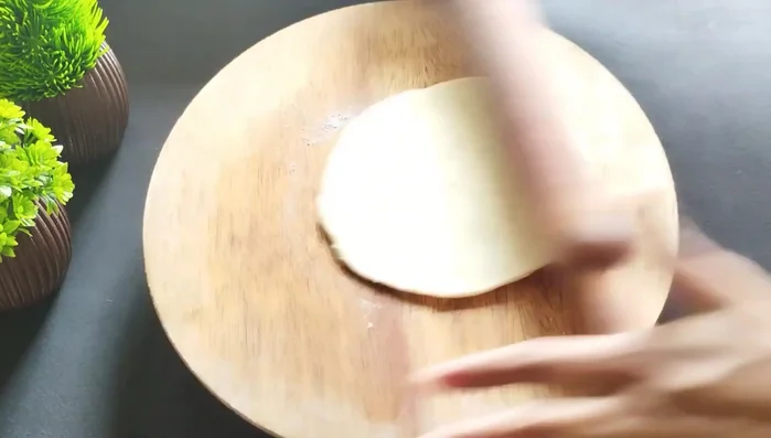 Roll each piece into a thin, round roti (neither too thin nor too thick).