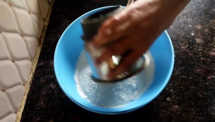 Add the ground semolina, 1/2 cup of sugar to the curd and mix well.