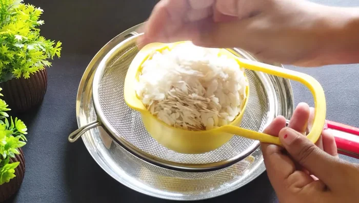 Sieve 2 cups of poha to remove white dust. Do not wash the poha.