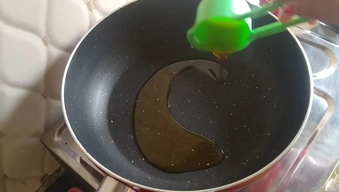 Heat a pan and add 3 tablespoons of oil. Once heated, add 1/2 teaspoon of cumin seeds and let them crackle.