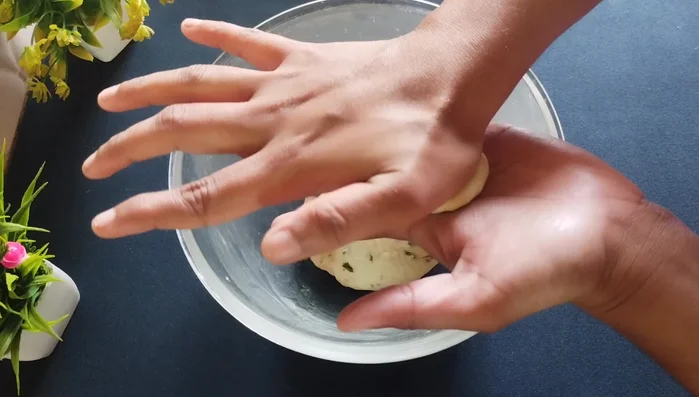 Flatten each ball into a circle, pressing only from the center. Do not press the edges.