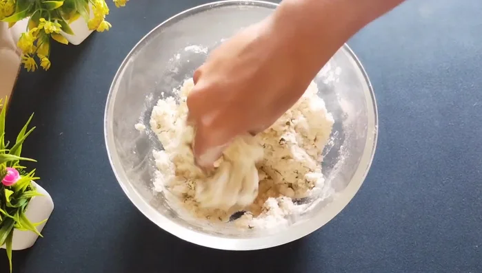 Gradually add water, mixing until a firm, hard dough forms. It shouldn't feel soft.