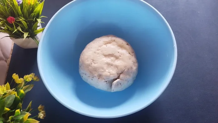 After resting, knead the dough again to make it smooth. Roll it into a long shape and cut it into smaller pieces.