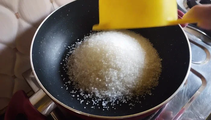 Make sugar syrup: In a separate pan, heat 1 ½ cups of sugar and ¼ cup of water over low heat until the sugar dissolves and the syrup thickens (about 5-6 minutes). A wire consistency is ideal.