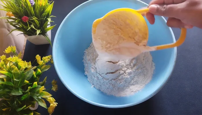 Take a bowl and add 2 cups of refined flour. Add 1 ½ teaspoon of celery (optional), a pinch of salt, and ¼ cup of refined oil/ghee. Mix well by rubbing the oil/ghee into the flour.