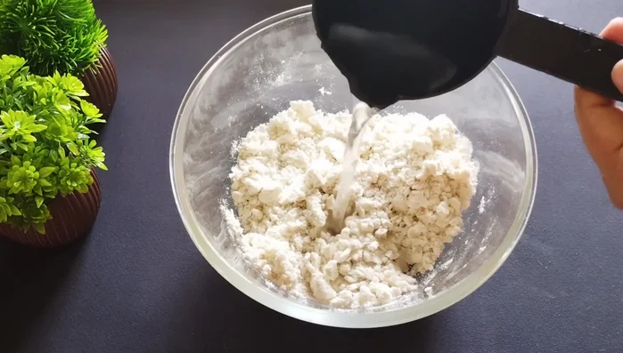 Gradually add water to form a stiff dough, similar to samosa dough. Avoid adding too much water.