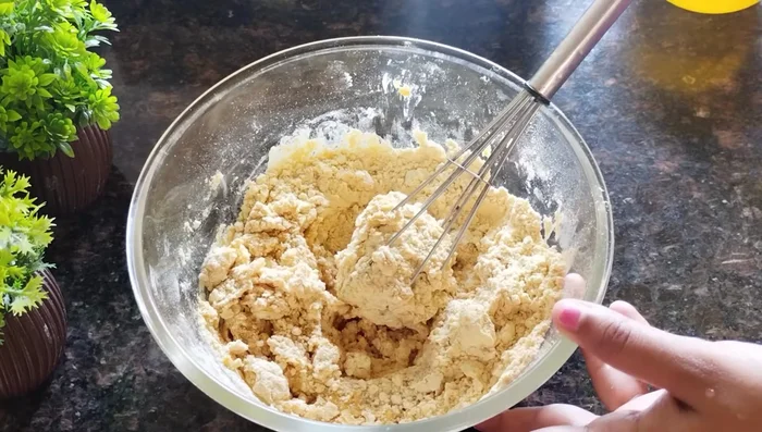 Gradually add water to the gram flour mixture, mixing until a smooth batter forms. Avoid adding too much water at once. Add yellow food coloring (optional).