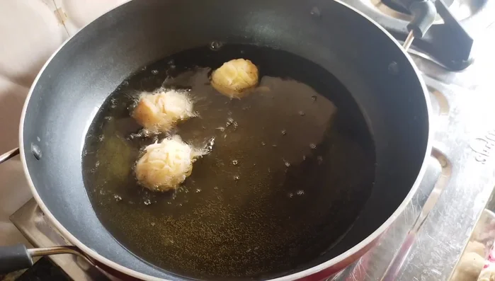 Fry the pakoras on high heat without disturbing them until lightly browned on one side. Gently flip and continue frying until golden brown and crispy.