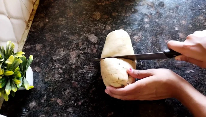 Divide the dough into two parts. Roll one part into a long cylinder shape.