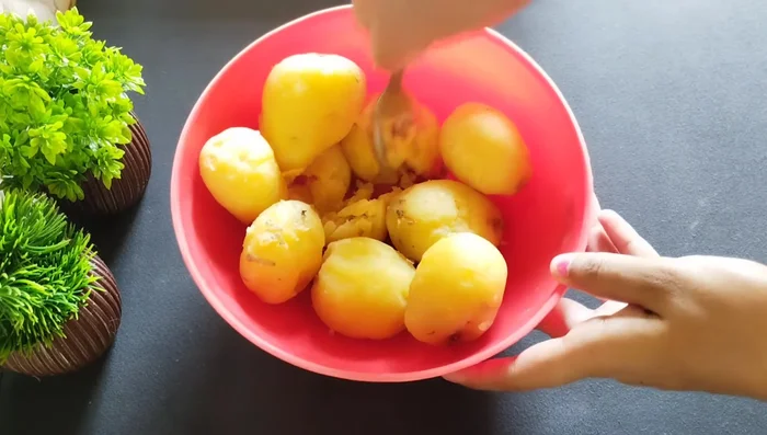 Peel and mash boiled potatoes. Don't overmash.