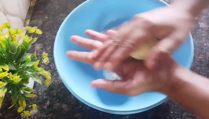 Divide the dough into small balls. Roll each ball into a very thin circle, thinner than a roti.
