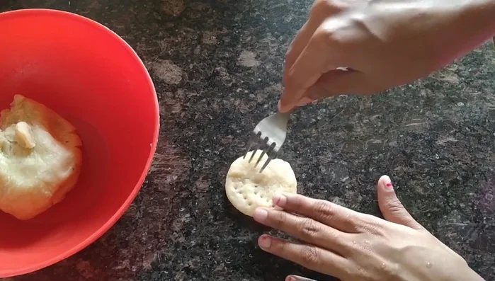 Use a fork or knife to prick holes in each disc to prevent puffing during frying.