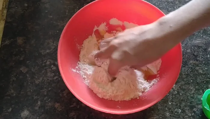 Gradually add oil while continuously mixing until a crumbly dough forms. Ensure the oil is well incorporated into the flour.