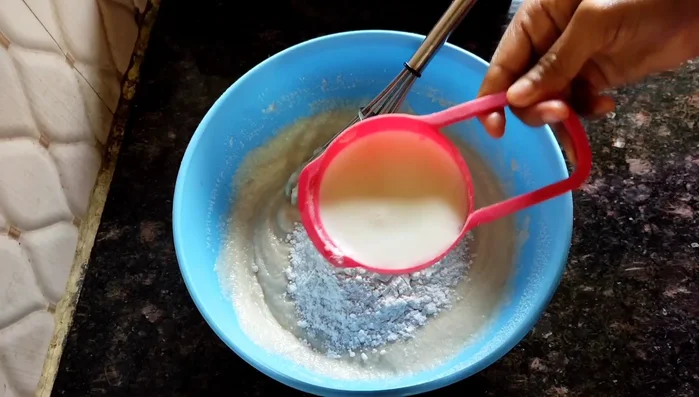 After an hour, add 1/2 cup flour and 1/2 cup milk (or water) to the semolina mixture. Mix well to remove lumps.