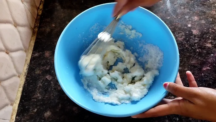 In a bowl, mix 1/2 cup curd and 1/2 cup sugar until light in color.