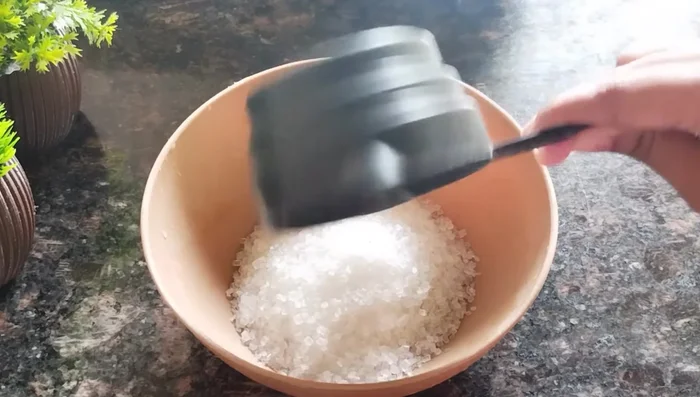 In a separate bowl, mix 1/2 cup of sugar (or jaggery) with a little water until the sugar dissolves slightly.