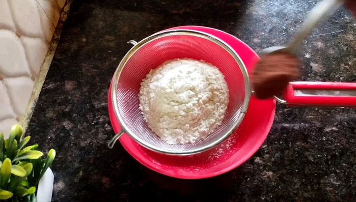 In a separate bowl, sift together flour and cocoa powder.