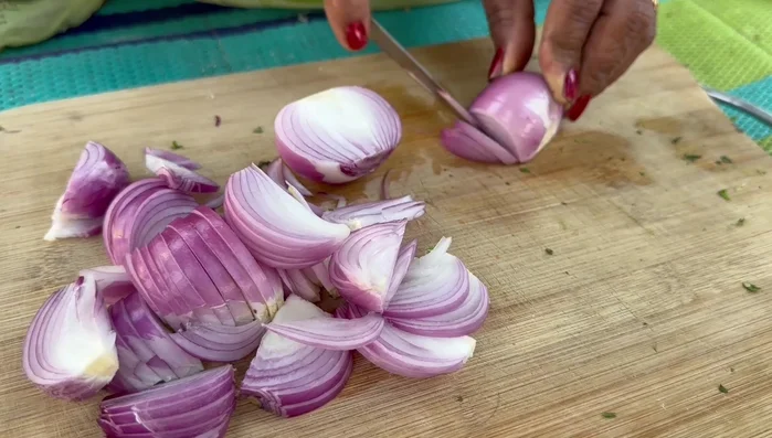 Cut onions into long pieces. Sift the gram flour for the pakodas.