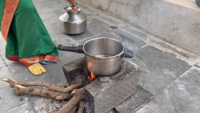 Cook the gram dal in a cooker with 2 cups of water until it releases 3-4 whistles. Add more water if necessary to ensure the dal is cooked properly.