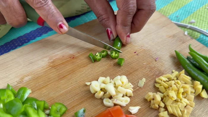 Prepare spices in advance: finely chop tomatoes, chilies, ginger, garlic, and capsicum.