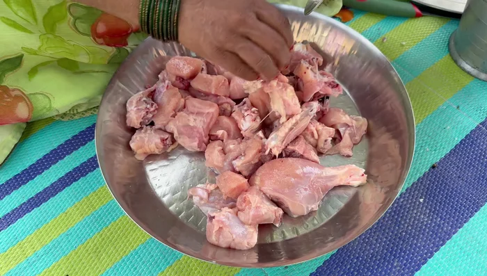 Add salt, turmeric powder, ginger, garlic, chili powder to the chicken.