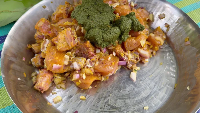 Apply the spice paste to the chicken pieces.